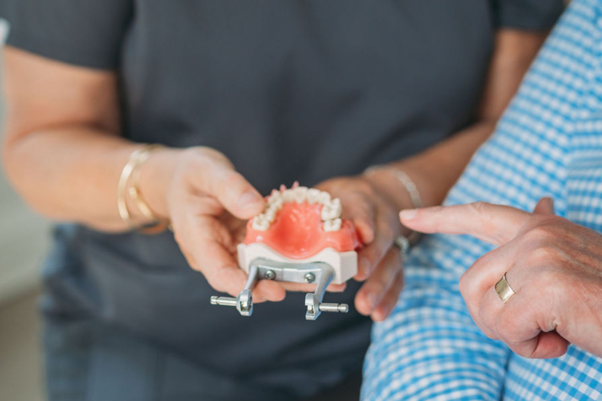 Dental implant model being discussed with a patient